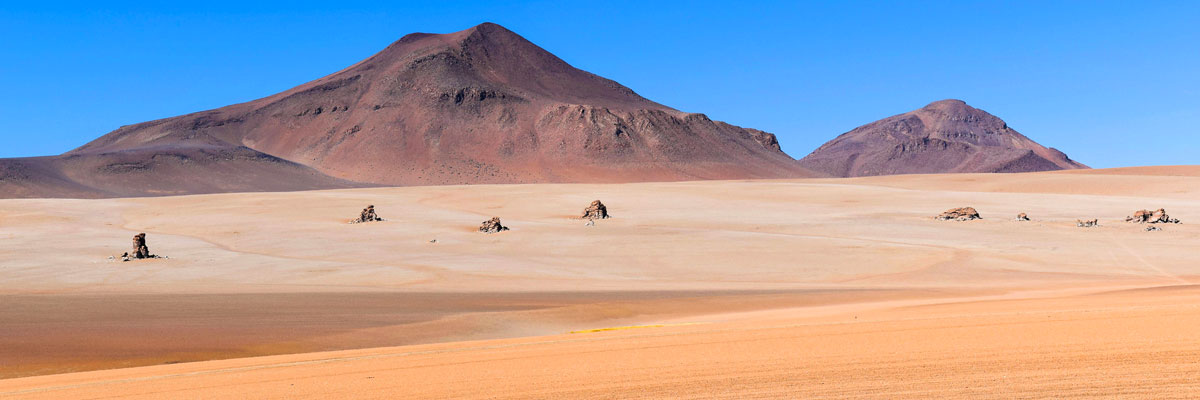 Uyuni Bolivia - Dali Desert and snow-covered mountain in the background